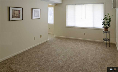Large living room with picture window at Crimson Heights Apartments in Albion, NY